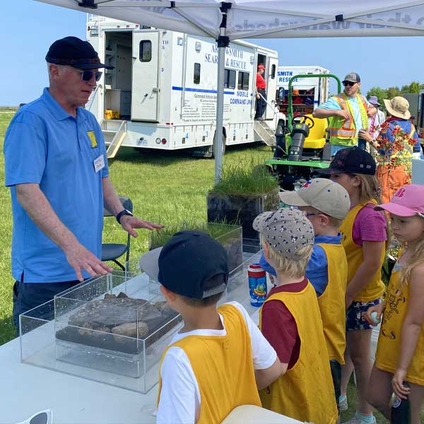 Children learning about salmon conservation during a MVIHES educational program